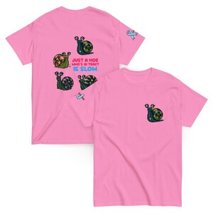May include: Pink t-shirts with snail graphics. One shirt has a small snail graphic on the pocket area. The other shirt has multiple snail graphics and the text "JUST A HOE WHO'S GI TRACT IS SLOW".