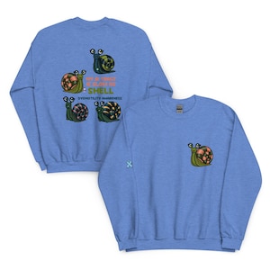 May include: Light blue sweatshirt featuring a snail graphic with the text "My Stomach is a Slow of Shell" and "Dysmotility Awareness". The design includes four cartoon snails on the back and one on the front pocket.