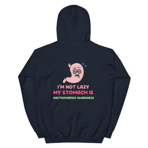 May include: Navy blue hoodie with a graphic of a sleeping stomach and the text "I'M NOT LAZY MY STOMACH IS GASTROPARESIS AWARENESS" in pink and green. The hoodie has a hood and long sleeves.