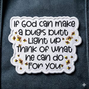 May include: White embroidered patch with black text that reads "If God can make a bug's butt light up think of what he can do for you." The patch has a scalloped edge and small yellow and brown firefly designs.