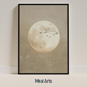May include: Framed art print featuring a large, textured moon in shades of beige and cream, with a flock of black birds in flight. The background is a muted, textured beige. The text "Miral Arts" is at the bottom.