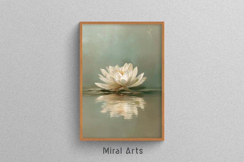 May include: A framed art print featuring a white lotus flower floating on water. The flower is reflected in the water below. The background is a soft, muted green. The frame is a light brown color. The text "Miral Arts" is at the bottom.
