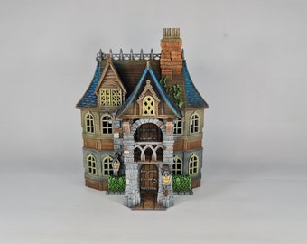 May include: A detailed miniature house with a brown, blue, and gray color scheme. The house features a stone facade, arched doorway, and a chimney. Decorative lanterns flank the entrance, and the roof has a blue tile design.