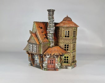 May include: A detailed miniature fantasy house with a weathered appearance. The house features a stone base, wooden walls, and a red-tiled roof. A tall chimney and a multi-story tower add to the whimsical design. The windows are small and rectangular.