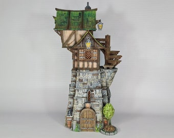 May include: A miniature stone tower with a wooden upper story and a green roof. The tower has a wooden door and windows, and a small garden with a bush and a stone path.