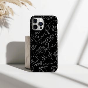 May include: Black phone case with a white line drawing pattern of cats in various poses. The case has a glossy finish and a camera cutout. The design features cats sleeping, sitting, and playing.