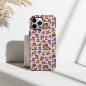 May include: A phone case featuring a repeating pattern of cartoonish, colorful creatures on a light pink background. The creatures have various colors, including brown, blue, and pink, with whimsical details. The case has a camera cutout and is designed for a smartphone.