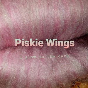 May include: Pink and white fuzzy yarn with the text "Piskie Wings I glow in the dark" on it.