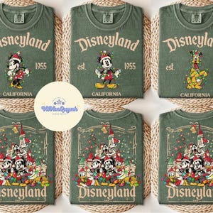 May include: Green t-shirts with Disneyland graphics. The shirts feature Mickey Mouse, Minnie Mouse, and Pluto in festive designs. The text "Disneyland" and "California" are also visible.