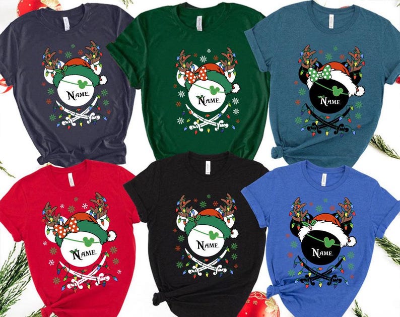 May include: A collection of Christmas-themed t-shirts in various colors, each featuring a festive design. The design includes a mouse head wearing a Santa hat and reindeer antlers, with the word "Name" and crossed swords.