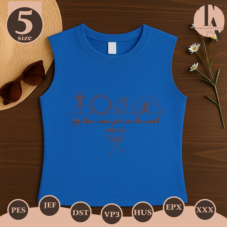 May include: A sleeveless blue top with the word "TORA" and the phrase "He has won just as he said" in a copper-colored script. The top is size 5. Sunglasses and a straw hat are in the background.