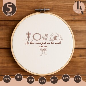 May include: An embroidery hoop with a cream-colored fabric featuring a brown embroidered design. The design includes a cross, a crown of thorns, a lamb, and an empty tomb. The text "He has risen just as he said. LUKE 24:6" is also embroidered.