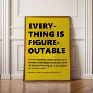 May include: A framed poster with the text "EVERYTHING IS FIGUREOUTABLE" in large black letters on a yellow background. The poster includes a paragraph of text below the main title, and is displayed against a white wall.