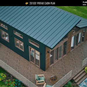 May include: A 26'x30' prefab cabin plan featuring a dark green exterior with a slanted metal roof, large glass sliding doors, and a spacious wooden deck with a herringbone pattern. The design includes multiple windows and a modern aesthetic.