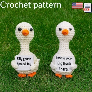 May include: Two handmade crochet geese with white bodies, black eyes, and orange beaks and feet. One holds a sign that reads "Silly goose Spread Joy," and the other reads "Positive goose Big Honk Energy." The text "Crochet pattern" is at the top.