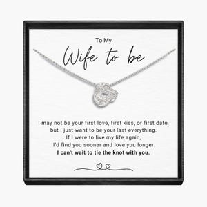 May include: A silver necklace with a knot pendant and a card that reads "To My Wife to be" with a message about love and marriage.