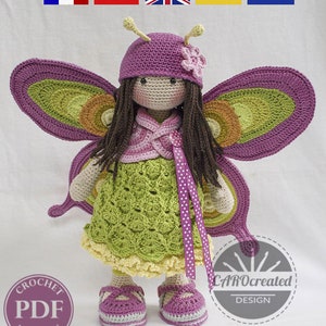 May include: Crochet pattern for a butterfly doll with purple wings, a green dress, and a purple hat. The doll has brown hair and a pink flower on her hat. The pattern is available as a PDF download. The text "CAROcreated DESIGN" is visible in the image.