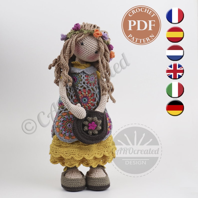 May include: Crochet doll pattern PDF in multiple languages. The doll is wearing a yellow dress with a colorful crocheted vest, a brown purse, and a flower crown. The doll has brown hair and brown eyes.