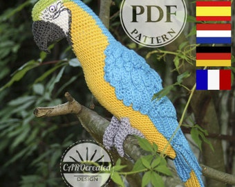 May include: Crochet pattern PDF for a blue and yellow parrot. The pattern is available in English, Spanish, German, French, and Dutch. The pattern is available for download as a PDF file.