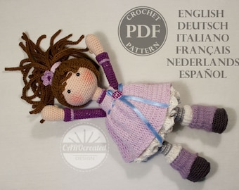 May include: A handcrafted crochet doll with brown hair, dressed in a lavender dress with a blue ribbon. The doll features a crocheted face with rosy cheeks and a purple flower. The image includes text that says "CROCHET PDF PATTERN" and lists several languages.