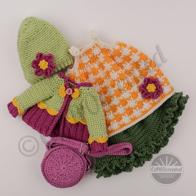 May include: A collection of handmade crochet clothing in various colors. The set includes a green hat with a pink flower, a green jacket with a purple skirt, an orange and white dress, and a purple purse.