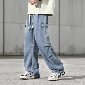 Men's Cargo Baggy Jeans | Straight Leg Denim Pants | Utility Pocket Streetwear Trousers | Y2K Fashion Gift for Him
.
Men’s baggy cargo jeans with straight-leg cut, elastic waist, and utility pockets, casual streetwear Y2K denim trousers.