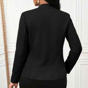 Women's Suede Jacket | Open Front Casual Blazer Coat | Chic Long Sleeve Outerwear | Elegant Fashion Layering Piece
.
Women's suede jacket with button details and open front design, tailored for chic layering and versatile outerwear. A stylish blazer-style coat for casual or formal outfits.