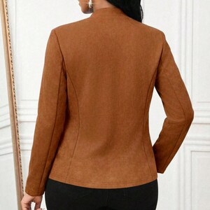 Women's Suede Jacket | Open Front Casual Blazer Coat | Chic Long Sleeve Outerwear | Elegant Fashion Layering Piece
.
Women's suede jacket with button details and open front design, tailored for chic layering and versatile outerwear. A stylish blazer-style coat for casual or formal outfits.