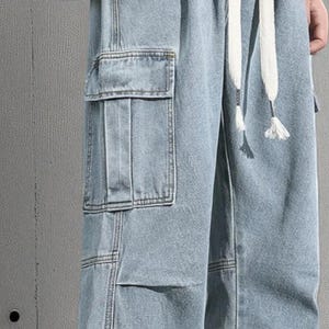 Men's Cargo Baggy Jeans | Straight Leg Denim Pants | Utility Pocket Streetwear Trousers | Y2K Fashion Gift for Him
.
Men’s baggy cargo jeans with straight-leg cut, elastic waist, and utility pockets, casual streetwear Y2K denim trousers.