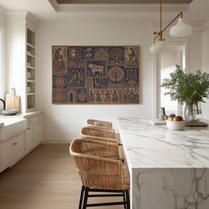 May include: A large rectangular wall art piece featuring a grid of intricate folk-style illustrations in shades of deep blue, red, and beige. The artwork displays various motifs including figures, a central cow, trees, birds, and floral patterns.