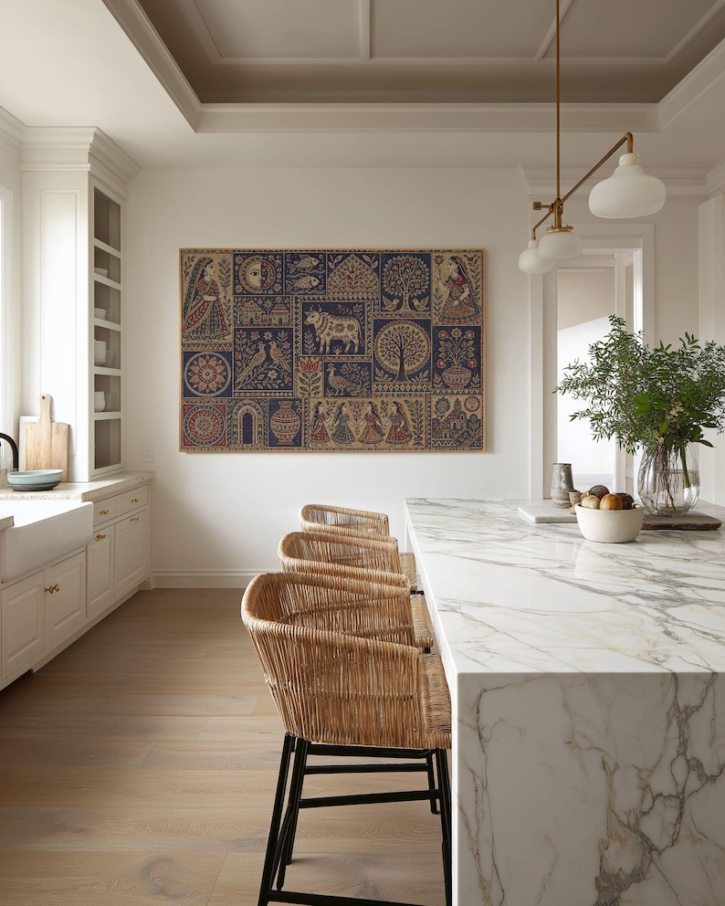 May include: A large rectangular wall art piece featuring a grid of intricate folk-style illustrations in shades of deep blue, red, and beige. The artwork displays various motifs including figures, a central cow, trees, birds, and floral patterns.