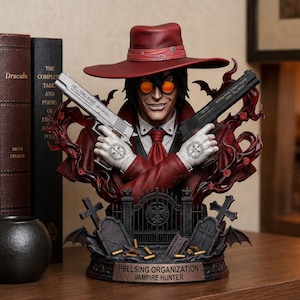 May include: A detailed bust of a character wearing a red hat, orange glasses, and a red suit, holding two handguns marked Hellsing Arms .454 Casull. The base features a cemetery scene with tombstones, a gate, and a plaque reading Hellsing Organization Vampire Hunter.