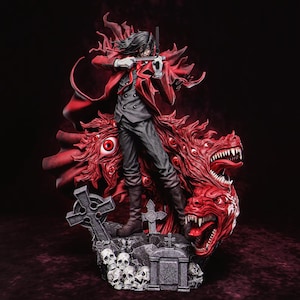 May include: A detailed figurine of a character in a red coat, holding a gun, standing atop a red, monstrous creature with multiple eyes and snarling faces. The base features a graveyard scene with skulls and tombstones.