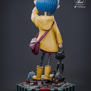 May include: A figurine of a girl with blue hair in a yellow raincoat, boots, and a maroon satchel. A black cat stands beside her. The figurine is on a base with a striped pattern.