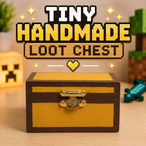 May include: A small, handmade wooden loot chest with a gold-colored body and dark brown trim. The chest has a decorative gold clasp and the text "TINY HANDMADE LOOT CHEST" in pixelated font.
