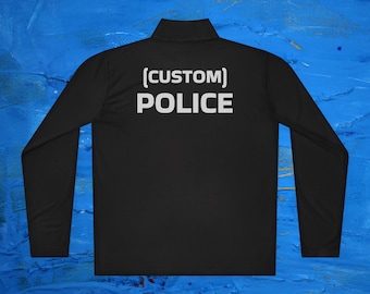 May include: Black long-sleeve shirt with a white zipper and the text "[CUSTOM] POLICE" on the back.