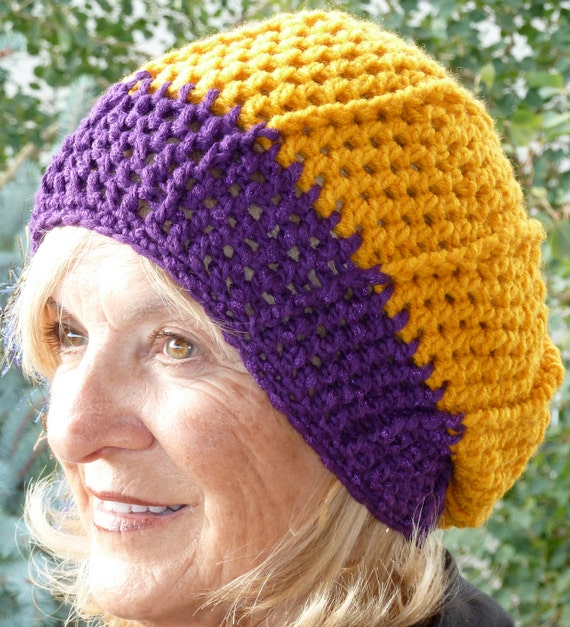 Handcrafted crochet hat created with a purple and gold team in