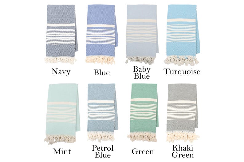 May include: Eight Turkish towels in various colors, including navy, blue, baby blue, turquoise, mint, petrol blue, green, and khaki green. Each towel has white stripes and fringe.