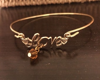 Golden Love Hangs on Bangle