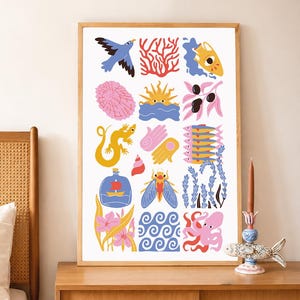 May include: A framed rectangular wall art print featuring a grid of colourful illustrations including a blue bird, red coral, a yellow pitcher, a pink sea urchin, a sun, olives, a yellow lizard, hands, fish, a ship in a bottle, a cicada, and an octopus.