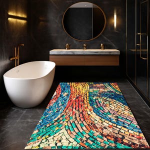 May include: A colorful mosaic-style bath mat with a vibrant pattern of red, blue, yellow, and green rectangular tiles. The mat is rectangular and placed on a dark gray tiled floor in a modern bathroom setting. A white bathtub is visible.