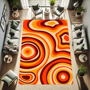 May include: A large, rectangular area rug with a retro design. The rug features concentric, swirling patterns in shades of orange, yellow, and brown. The rug is placed in a living room setting with furniture and plants.