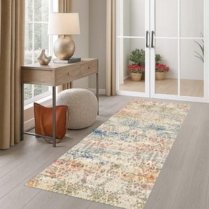 May include: A rectangular area rug with a distressed, vintage-inspired design. The rug features a mix of colors, including cream, blue, red, and gold. It is placed on a wooden floor in a hallway setting, adding a decorative element to the space.
