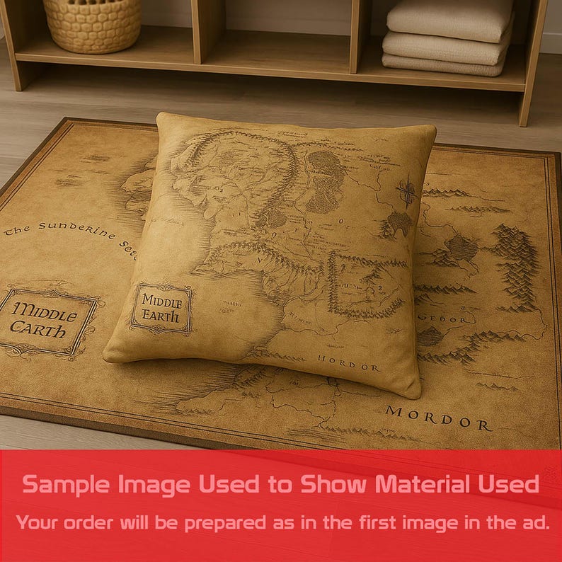 May include: A tan pillow with a map of Middle Earth on top of a matching rug. The rug and pillow have a vintage look. The rug has the words "Middle Earth" and "Mordor" printed on it.