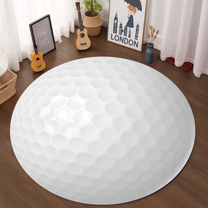 Könnte beinhalten: Runder weißer Golfball-Teppich mit strukturierter Oberfläche. Der Teppich hat einen Durchmesser von etwa 90 cm.