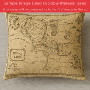 May include: Square pillow featuring a detailed map of Middle Earth in sepia tones. The pillow has a vintage aesthetic, with decorative elements including lion heads and a compass rose. The text "Middle Earth" is displayed prominently.
