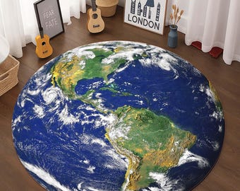 May include: A round blue and green rug with a detailed image of the Earth. The rug is on a wooden floor.