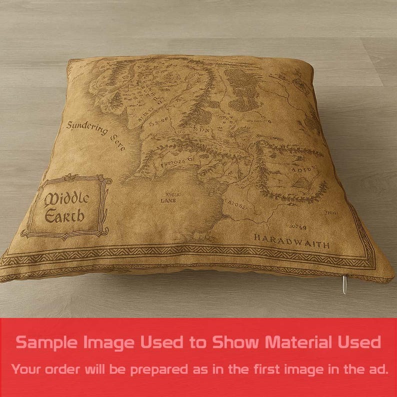 May include: A square pillow with a map of Middle Earth printed on it. The pillow is tan with a detailed map design in brown. The words "Middle Earth" are in a framed box on the pillow. The pillow has a zipper on the side.