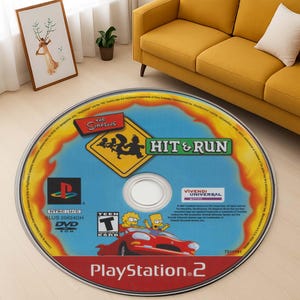May include: A blue and yellow PlayStation 2 game disc for The Simpsons: Hit & Run. The disc features a yellow road sign with the Simpsons family driving a red car. The game is rated Teen by the ESRB.
