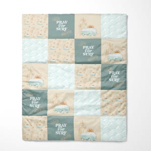 May include: A patchwork quilt with a beach theme. The quilt is made of various fabrics with different patterns, including palm trees, waves, and vintage vans. The text "Pray for Surf" is repeated on several of the squares.